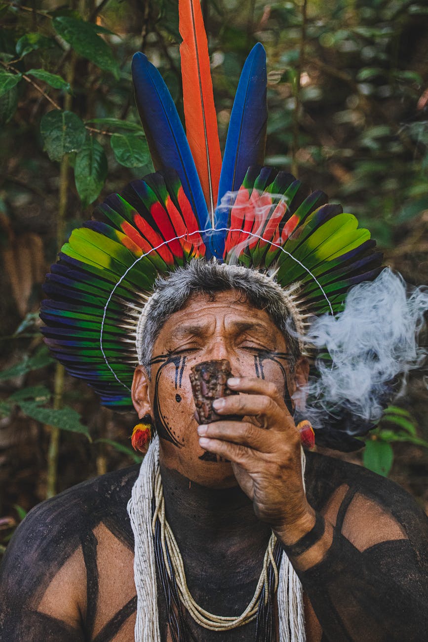 man in traditional plume smoking pipe